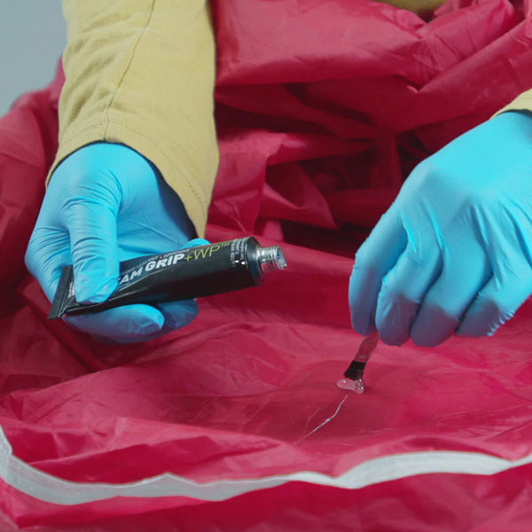 Gear Aid Seam Grip waterproof tent sealant being used on a tent flysheet