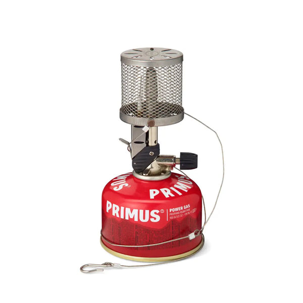 Primus Micron stainless steel lantern  with a power gas fuel canister and hanging line on a white background