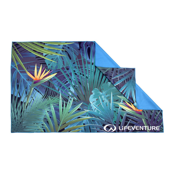Lifeventure soft fibre travel towel in tropical print laid out flat showing the reverse blue backing