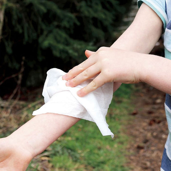 person using a deet free insect repellent wipe on their arm