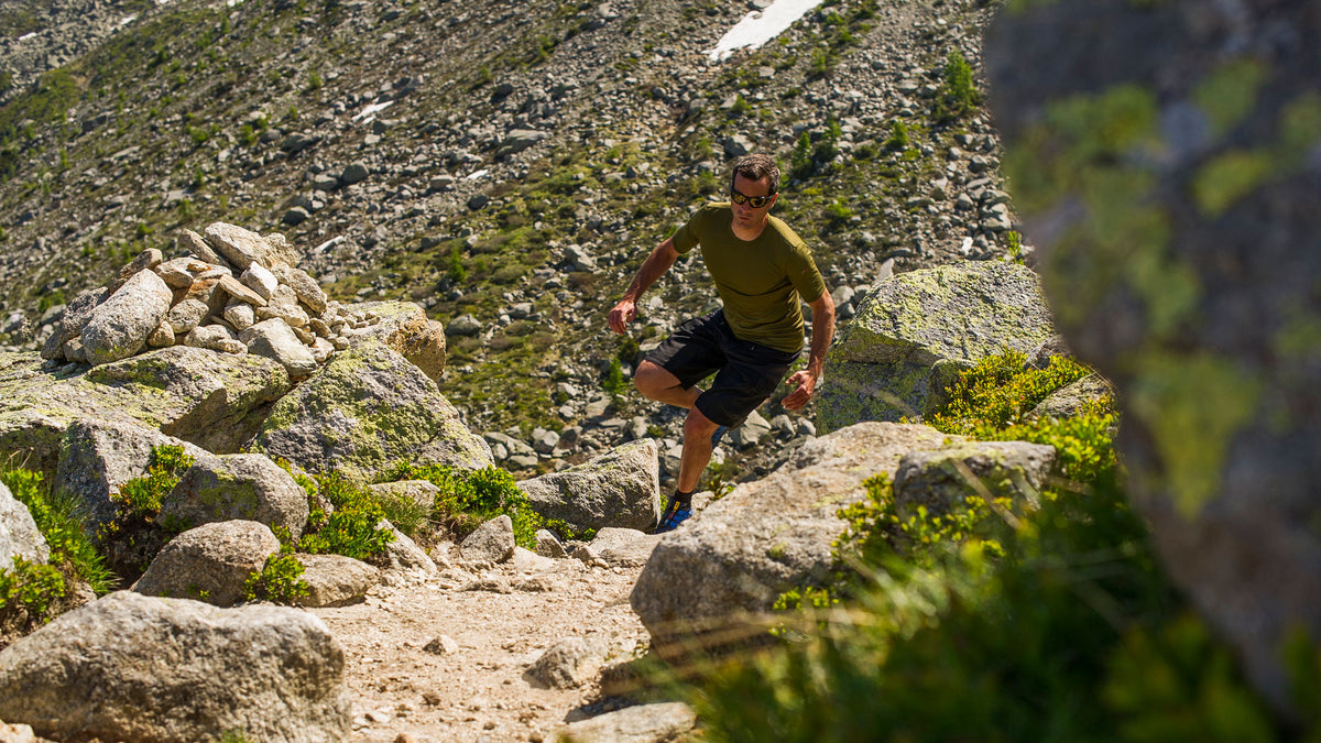 Mountain runner wearing a abse layer to manage perspiration and insulate the body from the cold