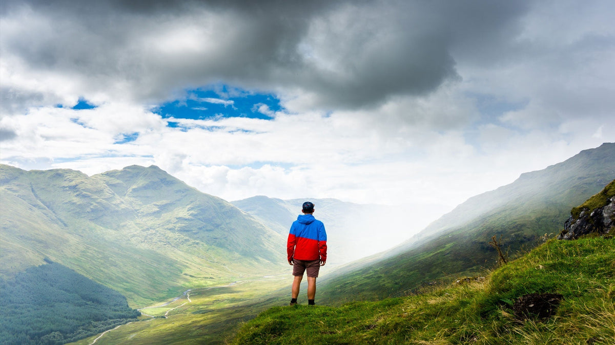 Man in shorts walking in the highlands during the summer months
