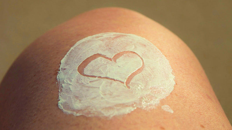 Sun cream applied to somebodies knee with a heart drawn in it