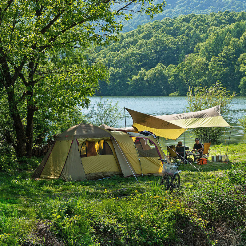 Family camping site set up next to a lake
