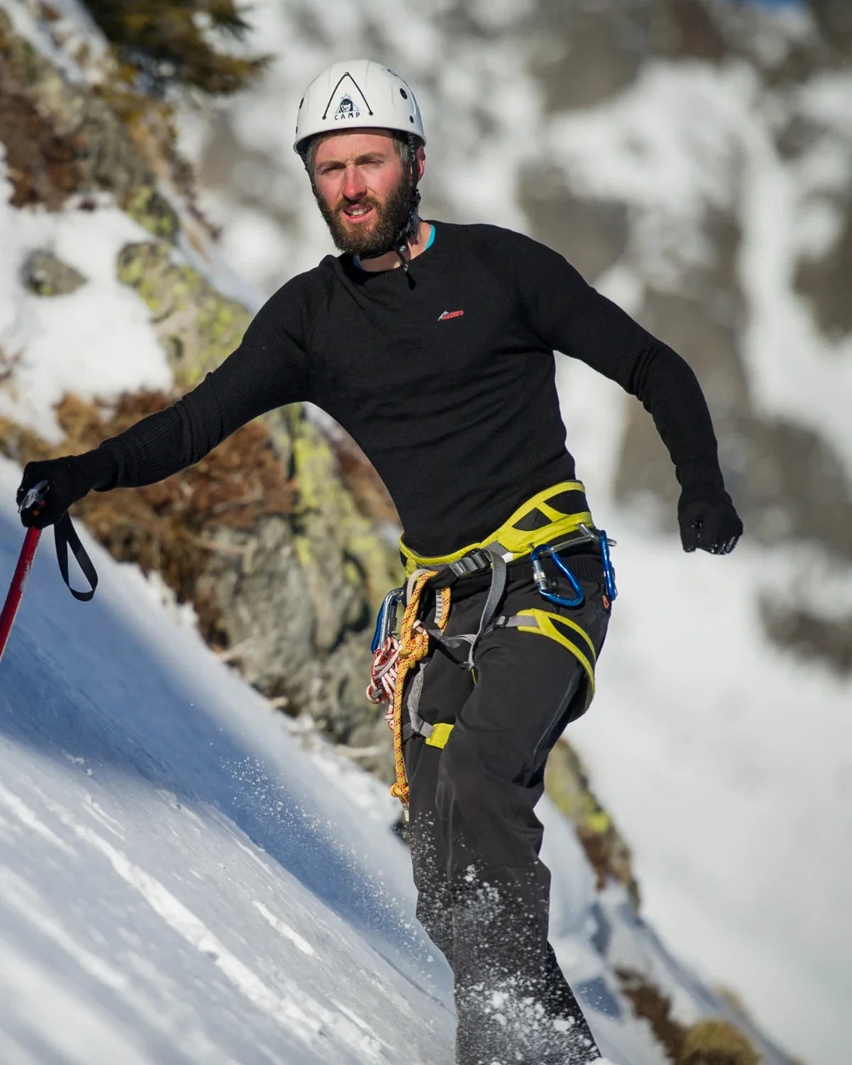 Man wearing Sub Zero technical clothing while mountaineering in snowy alpine terrain.