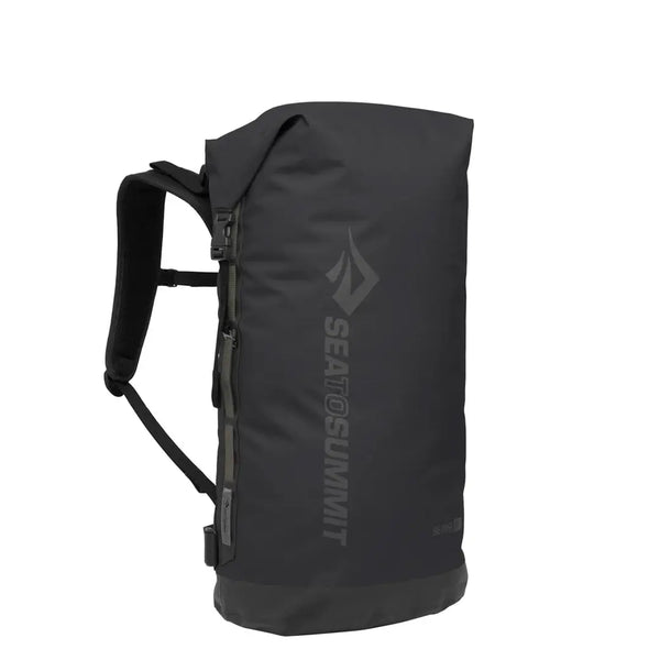 Sea To Summit Big River Dry Backpack in Black 50 Litres sitting upright and showing part of the strap