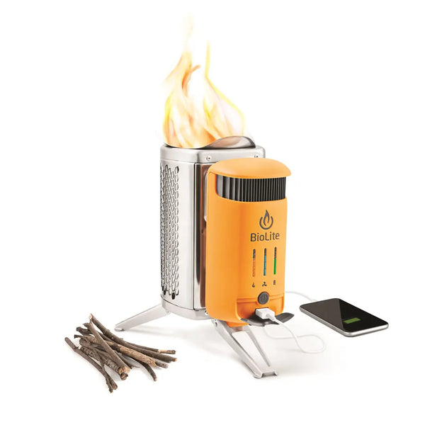 Biolite camp stove with flames, wood, and a phone on a white background