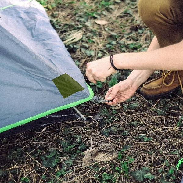 Coghlans nylon repair tape used on a tent corner to seal a tear