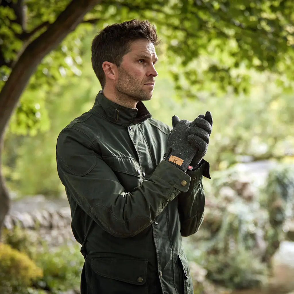 Lifestyle shot of a man outdoors wearing a pair of Extremities Furnace Pro Glove
