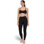 Woman wearing a black sports bra and Sub Zero Factor 1 Plus Stretch leggings in black on a white background