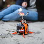 Lifestyle image of a Jetboil Fuel Can stabiliser legs being used on a gas canister whilst toasting a marshmallow