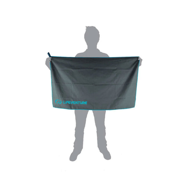 Pictorial image showing the relative size of a Lifeventure SoftFibre recycled travel towel in large grey in comparison to a person