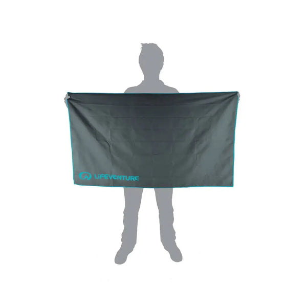 Pictorial image showing the relative size of a Lifeventure SoftFibre recycled travel towel in xlarge grey in comparison to a person