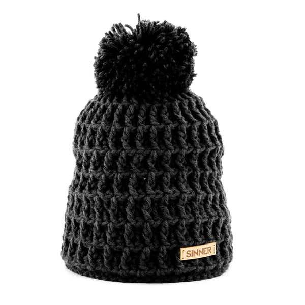 Front detail of a Sinner Nordic knitted beanie hat with a pompom in black