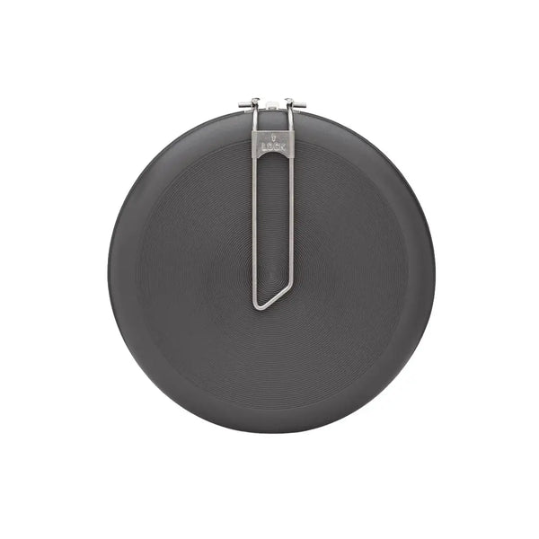 Close-up of the base of a large Primus Litech frying pan with the handle folded flat on a white background