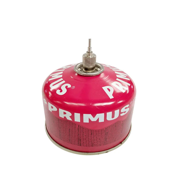 Primus stainless teel filling adaptor installed ontop of a Primus power gas canister on a white background