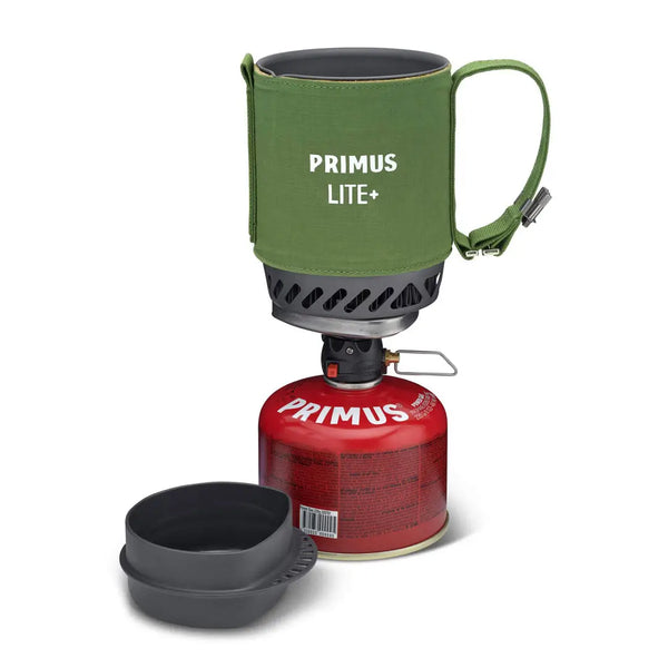 Primus Lite+ camping stove with green carrying case and red fuel canister on a white background