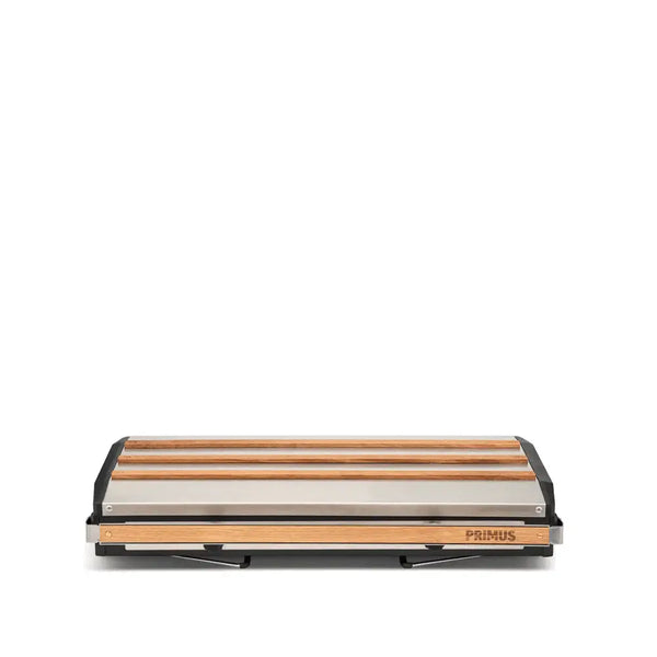 Primus Tupike gas stove folded away for transport on a white background