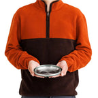 Person holding a fully collapsed Sea To Summit Detour Stainless Steel Collapsible Bowl in green colour to show the size equivalence