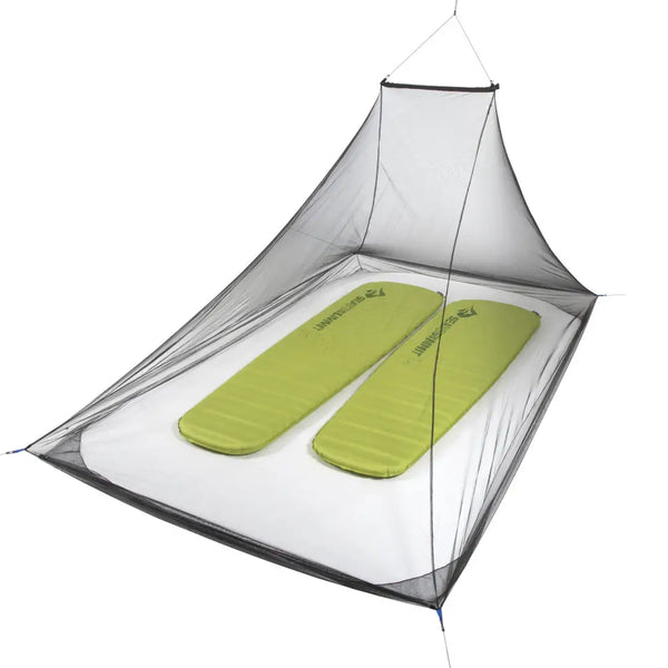 Sea To Summit Pyramid Double Mosquito Net set-up with two sleeping mats inside on a white background