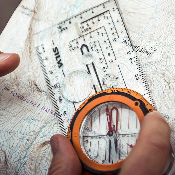 Lifestyle image of a Silva Expedition compass bein used with an OS map