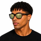 Man with his head turned to the side wearing Sinner Rockford polarised sunglasses in matte brown colour on a white background