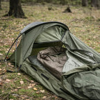 Lifestyle shot of the entry to a pitched Snugpak Stratosphere Bivi Shelter in the woods