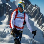 Lifestyle shot in the alps of a man wearing a white Sub Zero Factor 2 mens mid layer thermal top whilst skiing