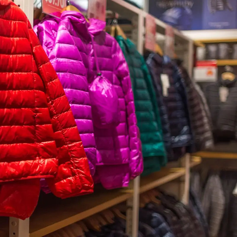 Colourful insulated jackets displayed in an outdoor clothing retail store
