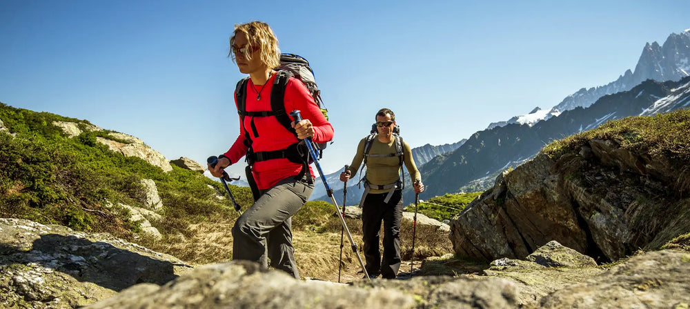 Two walkers wearing sub zero thermal base layers whilst walking in the mountains during summer