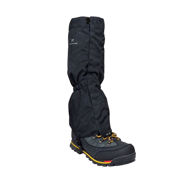 Studio shot of an Extremities Field Gaiter worn with a climbing boot on a white background