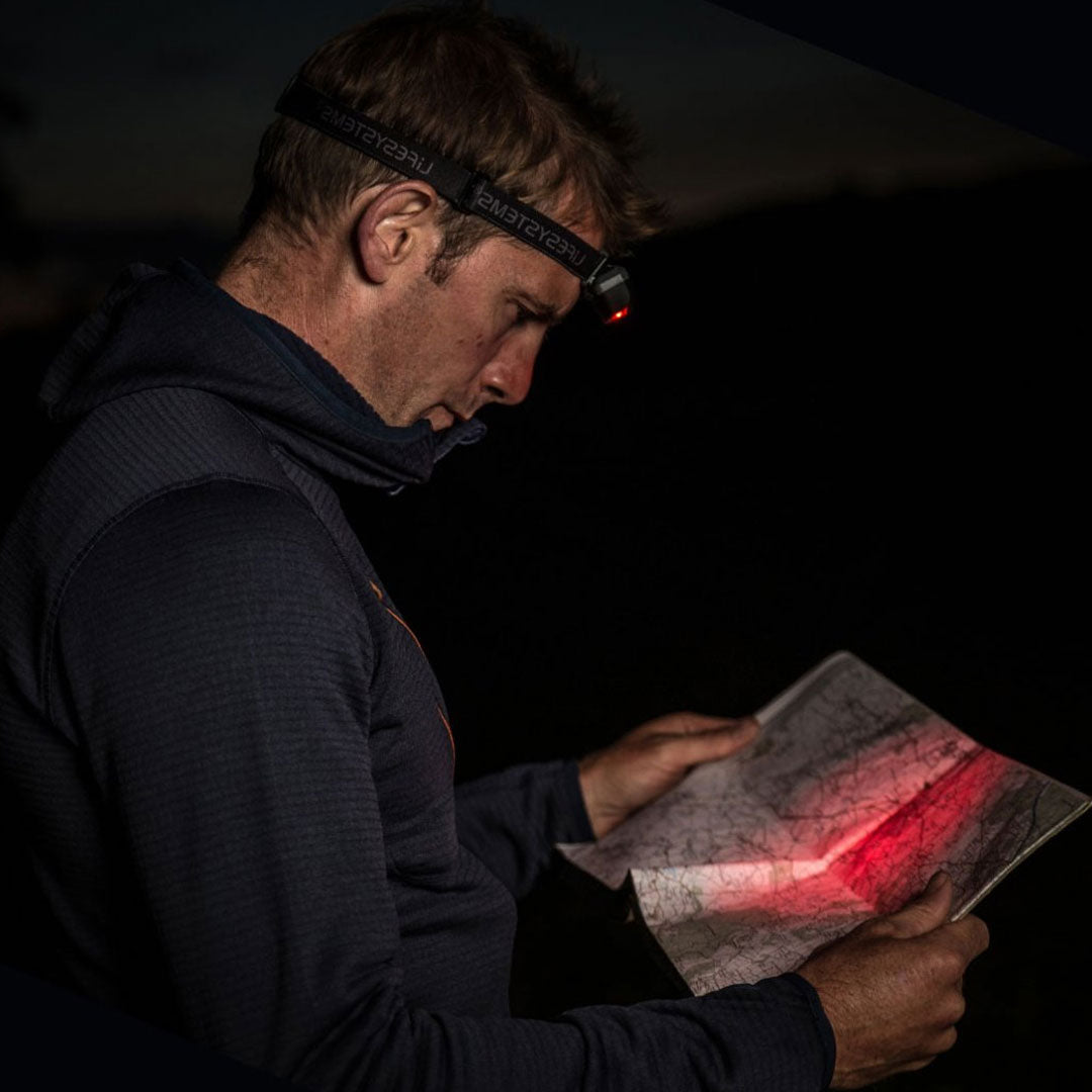 Lifesystems Intensity 155 Lumens LED Head Torch being used in the night vision red LED mode to view a map in the dark